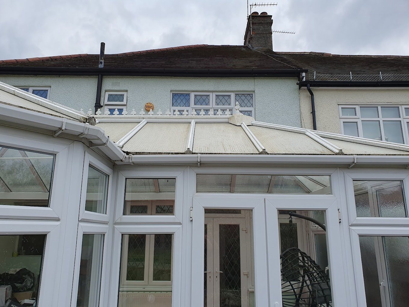 Green polycarbonate conservatory roof in Essex before cleaning